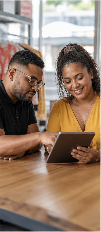 A website builder reviewing a mobile site with a local shop owner